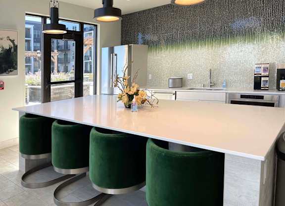 a kitchen with a long island and green stools at 42 Hundred On The Lake, Wisconsin, 53235