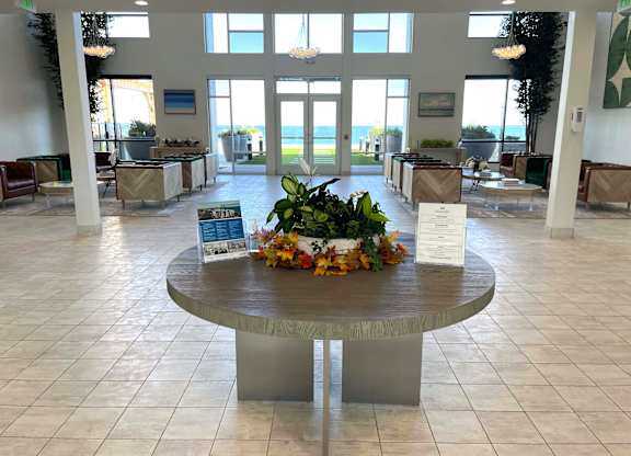 a large lobby with a table with a plant on it at 42 Hundred On The Lake, St Francis, WI