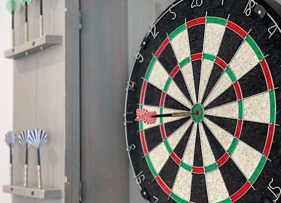 a dartboard on the wall of a darts club at 42 Hundred On The Lake, St Francis, 53235