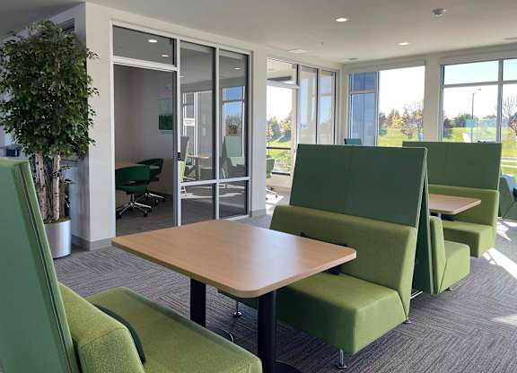 a seating area with tables and chairs in a room at 42 Hundred On The Lake, St Francis, 53235