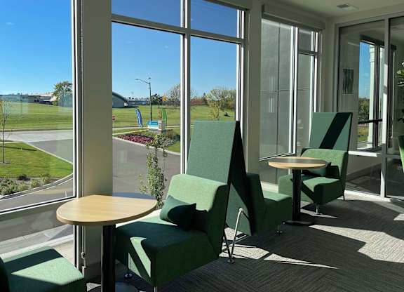 a group of chairs and tables in a room with large windows at 42 Hundred On The Lake, St Francis, WI, 53235