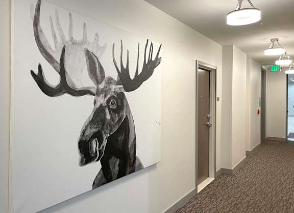 a moose mural on a wall in an office hallway at 42 Hundred On The Lake, Wisconsin