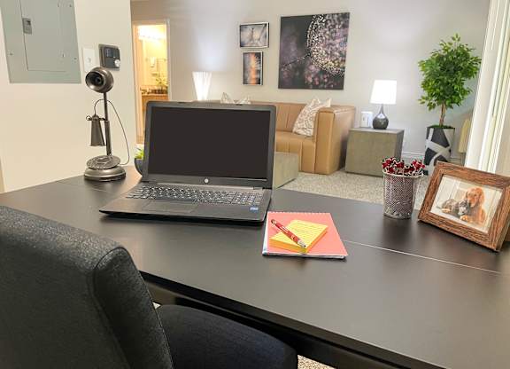 a laptop computer sitting on a desk in a living room at Fieldpointe of Schaumburg, Schaumburg, IL, 60173