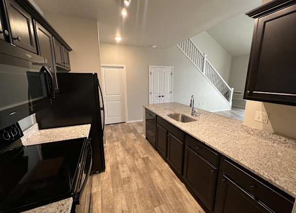 Kitchen with black appliances at Fountain Ridge, Pleasant Prairie, 53158