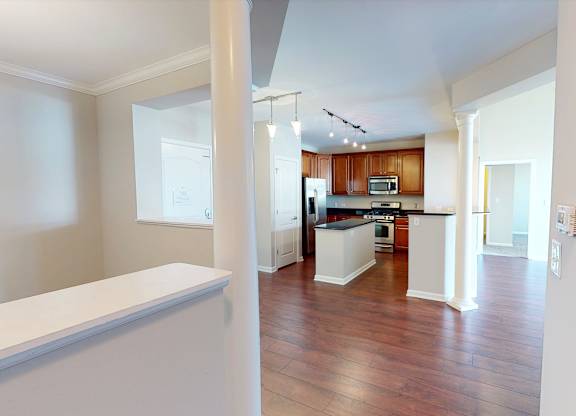 A kitchen with wooden floors and white walls.