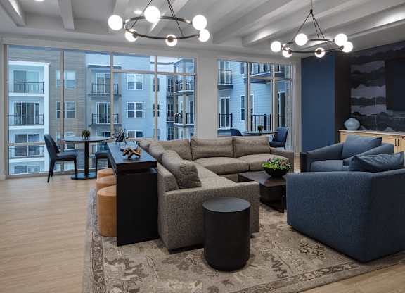 a living room with blue walls and a couch and a table at 2929 on Mayfair, Wauwatosa, WI