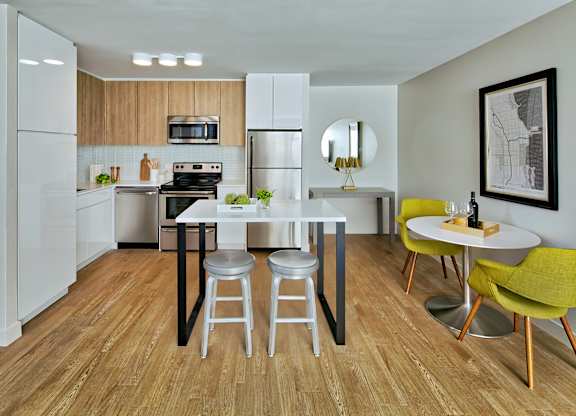a kitchen and dining room with a white table and chairs at The Kent, Chicago, IL, 60614