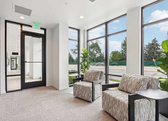 A room with a black door and a carpet on the floor.
