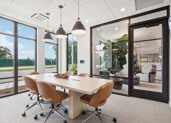 A conference room with a long table and chairs.