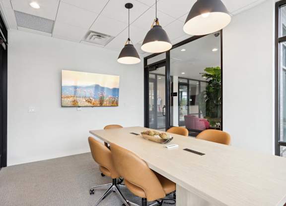 A conference room with a long table and chairs.