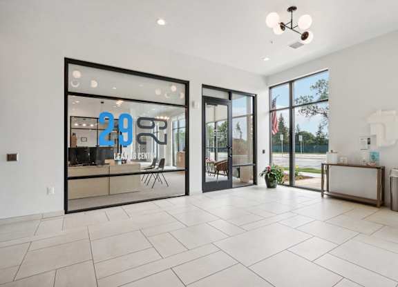 A spacious room with a large glass door and a tiled floor.