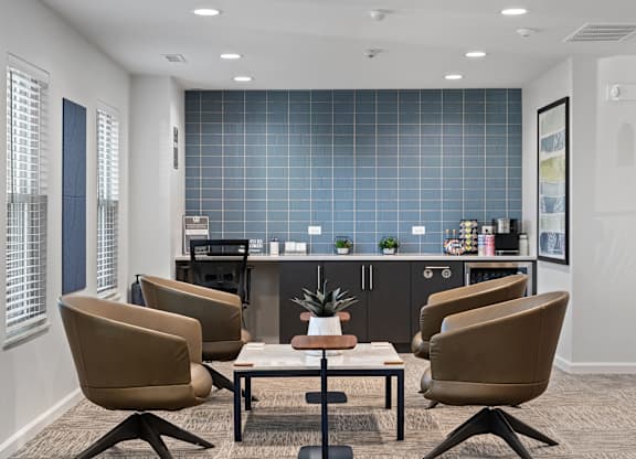 A conference room with a table surrounded by chairs.