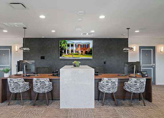 A conference room with a large screen displaying a house image.