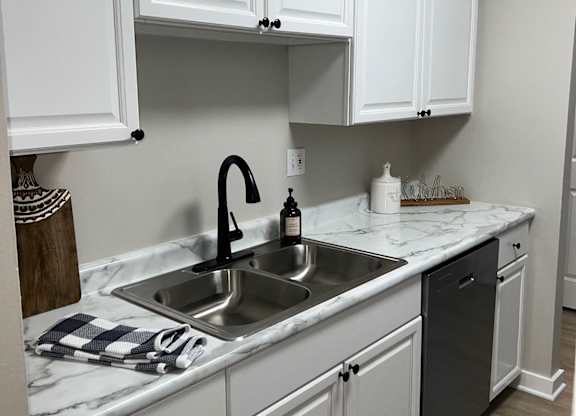a kitchen with white cabinets and a sink at Fieldpointe of Schaumburg, Schaumburg, IL