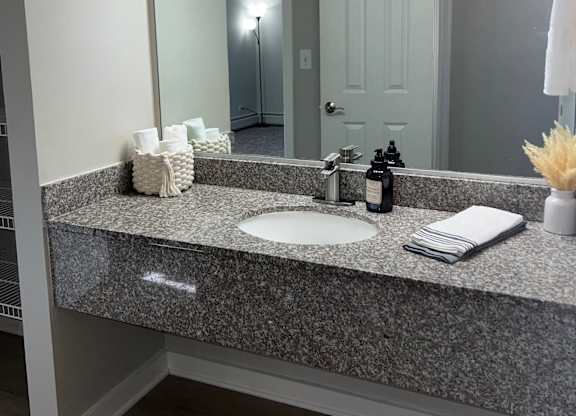 a bathroom with a sink and a large mirror at Fieldpointe of Schaumburg, Schaumburg, 60173