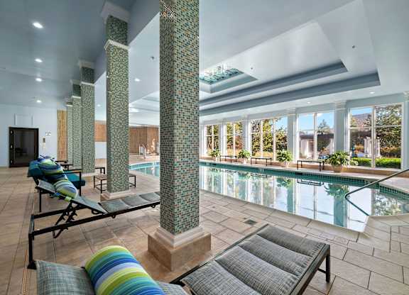 Indoor swimming pool with relaxing seating.