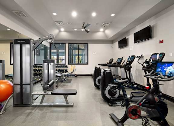 Fitness Center with a variety of equipment including treadmills, stationary bikes, and weight machines.