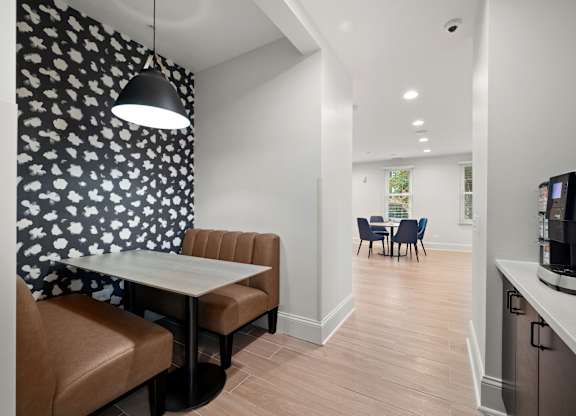 A modern kitchen with a dining table and chairs.