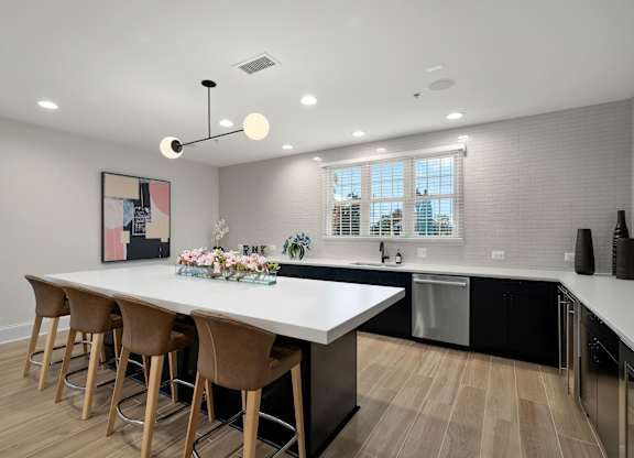A modern kitchen with a large island and bar stools.