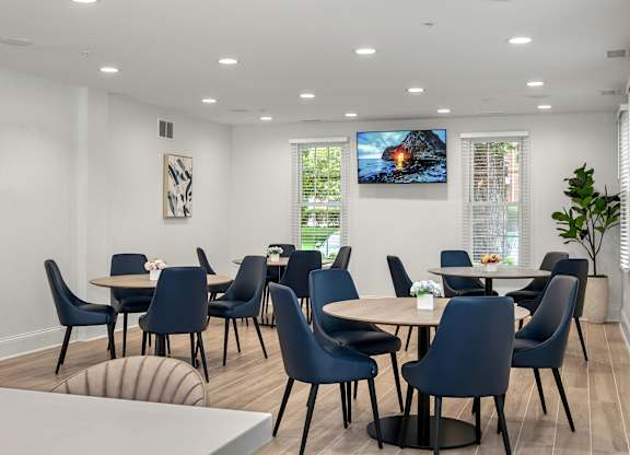 A modern dining room with a TV mounted on the wall.