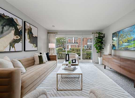 A living room with a large painting on the wall and a flat screen TV mounted on the wall.