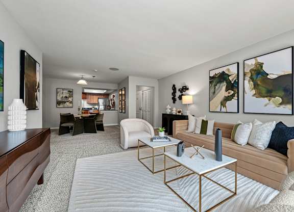 A living room with a white sofa and a coffee table.