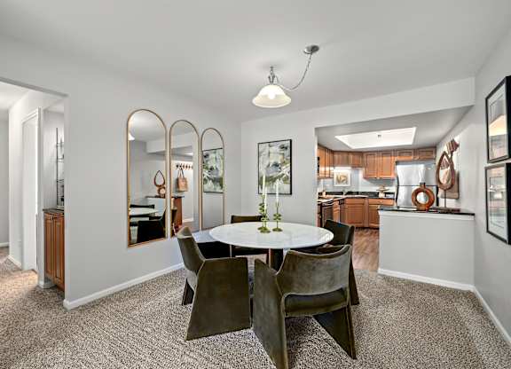 A dining room with a round table and chairs.