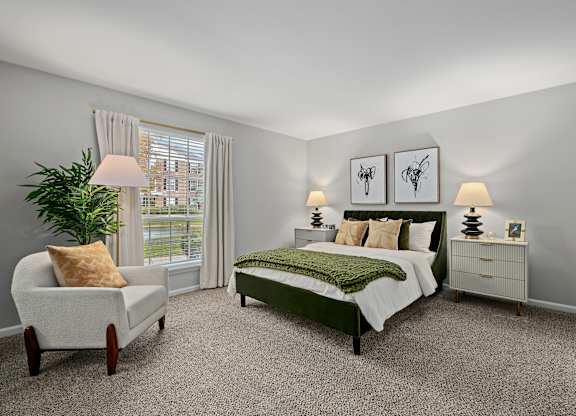 A bedroom with a bed, nightstand, chair, and lamp.