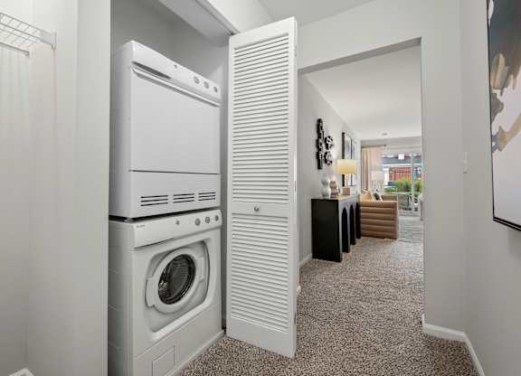 A white washing machine and dryer in a laundry room.