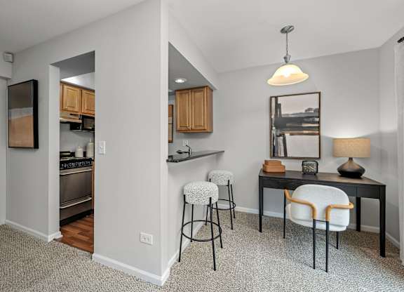A kitchen with a table and chairs in the middle of the room.