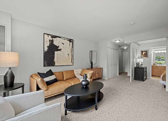 A living room with a couch, coffee table, and lamp.