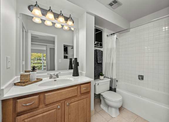 A bathroom with a white sink, toilet, and bathtub.