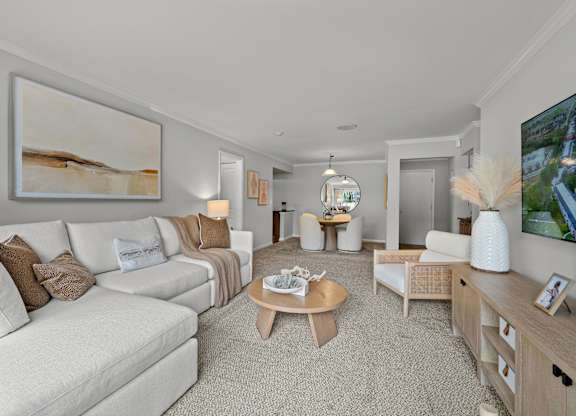 A living room with a white couch and a coffee table.