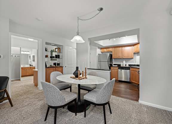A modern kitchen with a dining table and chairs.