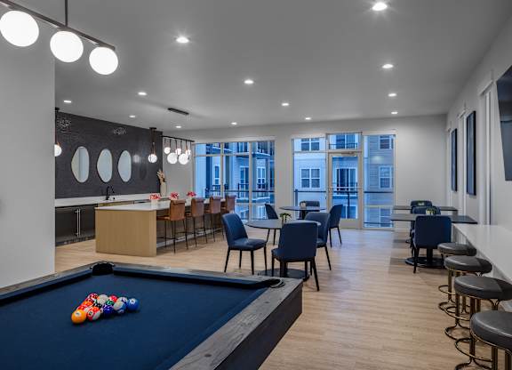 a communal area with a pool table and tables and chairs and a bar at 2929 on Mayfair, Wauwatosa, Wisconsin
