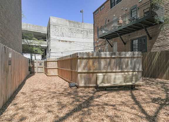 A backyard with a wooden fence and a small shed.