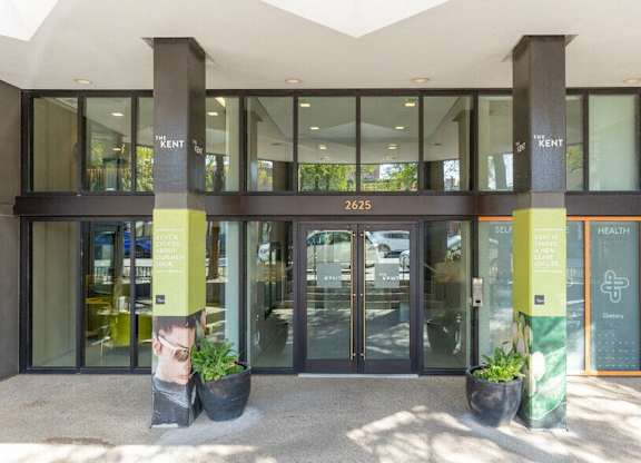 The front of a building with a glass door and a sign that says Kent.