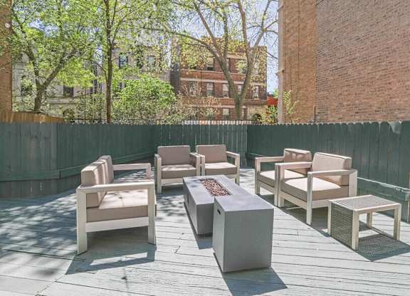 A set of outdoor furniture is arranged on a wooden deck.