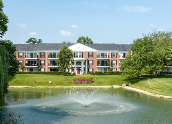 A building with a fountain in front of it at Versailles on the Lakes Oakbrook*, Illinois
