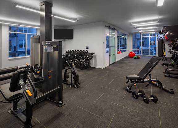 a gym with cardio equipment and weights in a building at 2929 on Mayfair, Wauwatosa