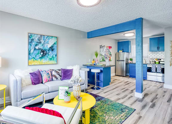 Fusion Las Vegas 1 bedroom apartments in Vegas living room with a white couch and a yellow coffee table.