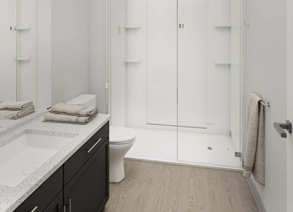 Altura Apartments bathroom designed with a spacious walk-in shower enclosure.