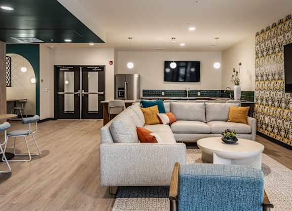 Altura Apartments spacious yoga studio equipped with a television screen for instruction or entertainment.