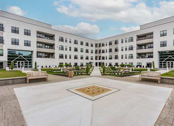 A courtyard with a square in the middle surrounded by apartment buildings.
