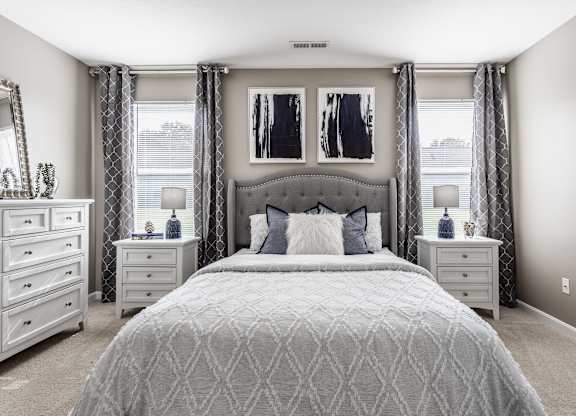 Bedroom at Bedford Place Apartments filled with natural light from large windows, creating a warm and inviting space
