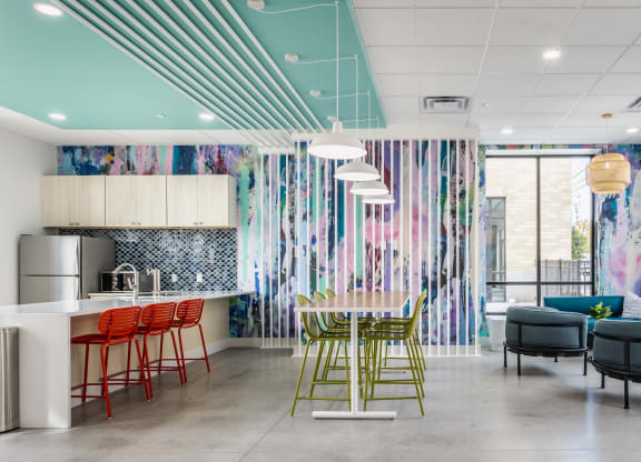 A lounge with a selection of seating areas, light fixtures, and stylish decor.