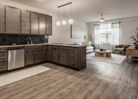 This modern kitchen boasts rich dark wood cabinets and a full suite of stainless steel appliances for convenient cooking.