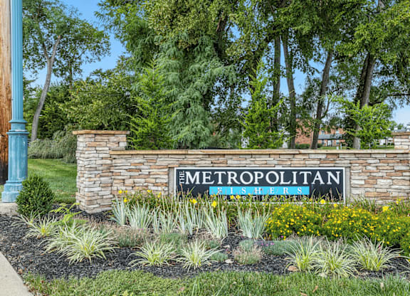 A sign that says Metropolitan in front of a building.