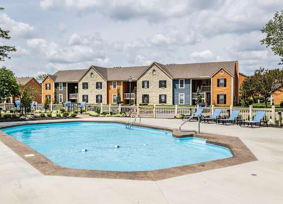 A swimming pool surrounded by chairs and concrete at Fairway Lakes in Westerville, OH.