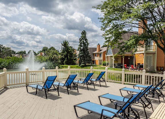 A selection of blue lounge chairs with a view of a fountain pond in Westerville, OH.